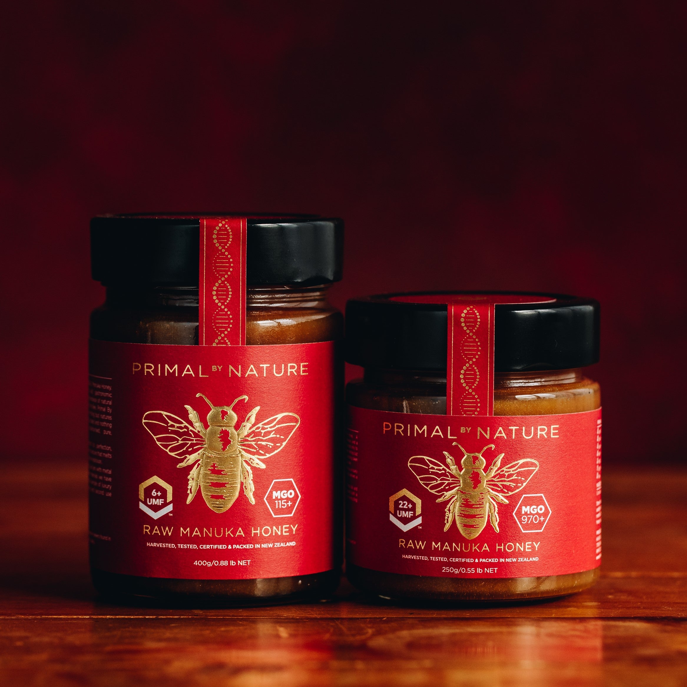Primal by Nature Glass Jar Genuine 100% Pure Manuka Honey Jar UMF 6+ MGO 115 400g Jar next to UMF 22+ MGO 970 250g Jar