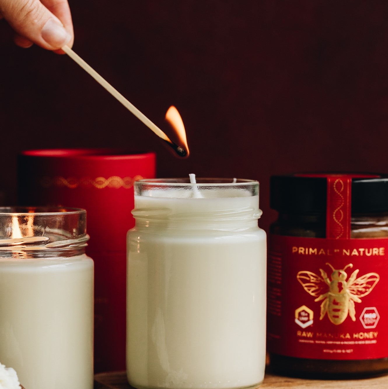 Primal by Nature Glass Jar Genuine 100% Pure Manuka Honey Jar set amongst reused glass jar candles