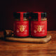 Primal by Nature Glass Jar Genuine 100% Pure Manuka Honey Jars UMF 13+ MGO 400 next to UMF 5+ MGO 83 on a cutting board